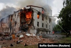 Пожарные работают на месте обрушения здания в результате удара российского беспилотника, Харьков 7 июня 2025 года