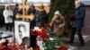 People lay flowers at the grave of Russian opposition leader Aleksei Navalny at the Borisovo Cemetery in Moscow on February 16.
