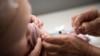 The child get shot with vaccine during supplementary immunization campaigns in response to the measles outbreak.