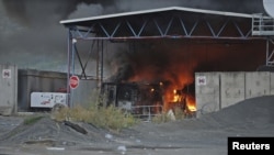 Kosovo -- The Serbia-Kosovo border crossing burns after masked Serb extremists set it on fire, Jarinje, 27Jul2011