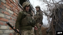 Ukrainian servicemen hold a position on the front line with Russia-backed separatists near the small city of Marinka in the Donetsk region on April 12. Nearly 30 Ukrainian soldiers have been reported killed since the start of the year.