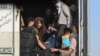 Afghan refugees arrive in the Islam Qala border crossing between Afghanistan and Iran on June 27, 2025, following their deportation from Iran.