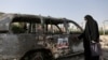 An Iranian woman looks at an ambulance burned in Israeli strikes on Tehran during the <a href="/a/khamenei-leadership-iran-irgc-military-takeover/33456933.html" target="_self">1<strong>2-day conflict</strong></a> between the two countries. 