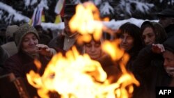Georgia -- Supporters of South Ossetia's presidential candidate Alla Dzhioyeva warm up near a fire during a rally in Tskhinvali, 01Dec2011