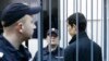 Petersburg, stands inside the defendant's cage as he attends a court hearing in Moscow, Russia, April 18, 2017